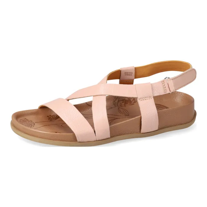 Pink sandal with a tan sole on a white background