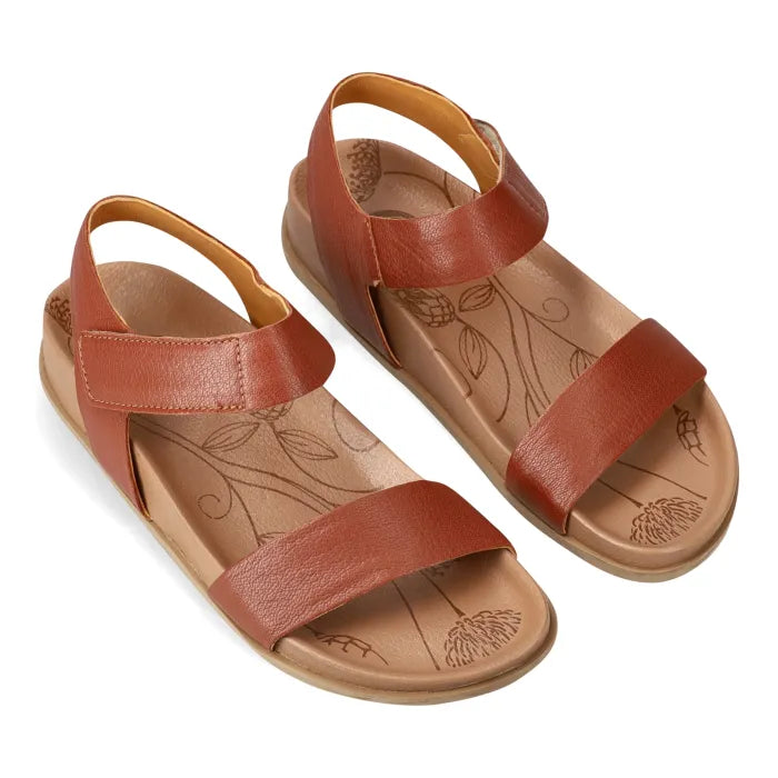 Pair of brown sandals with floral patterns on a white background