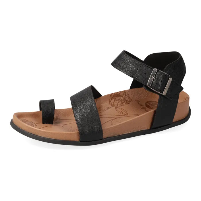 Black sandal with a brown sole on a white background