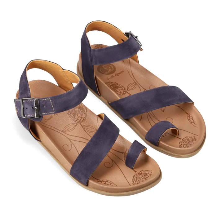 Pair of sandals with navy straps on a white background