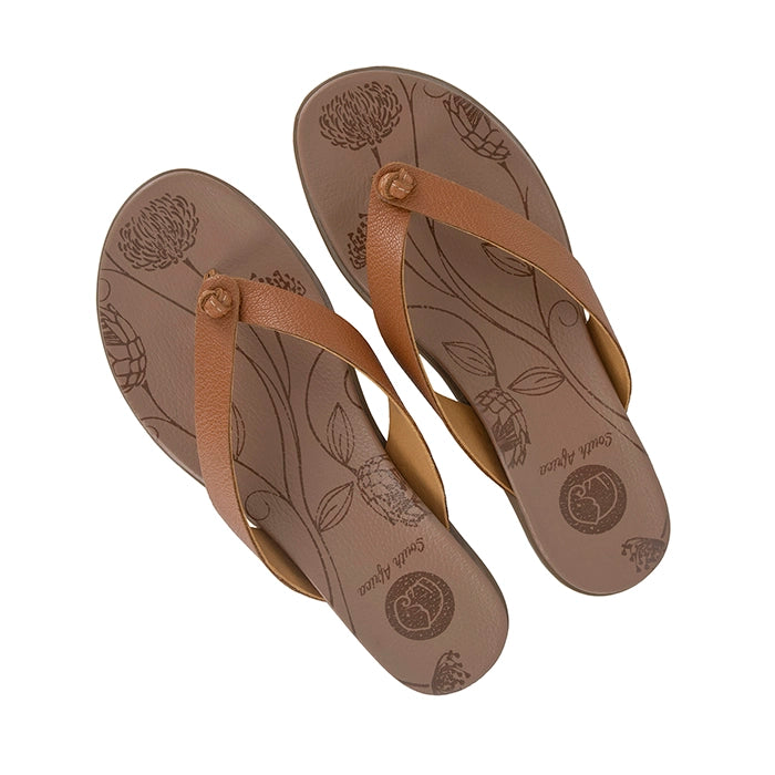 Pair of tan flip-flops with floral patterns on a white background