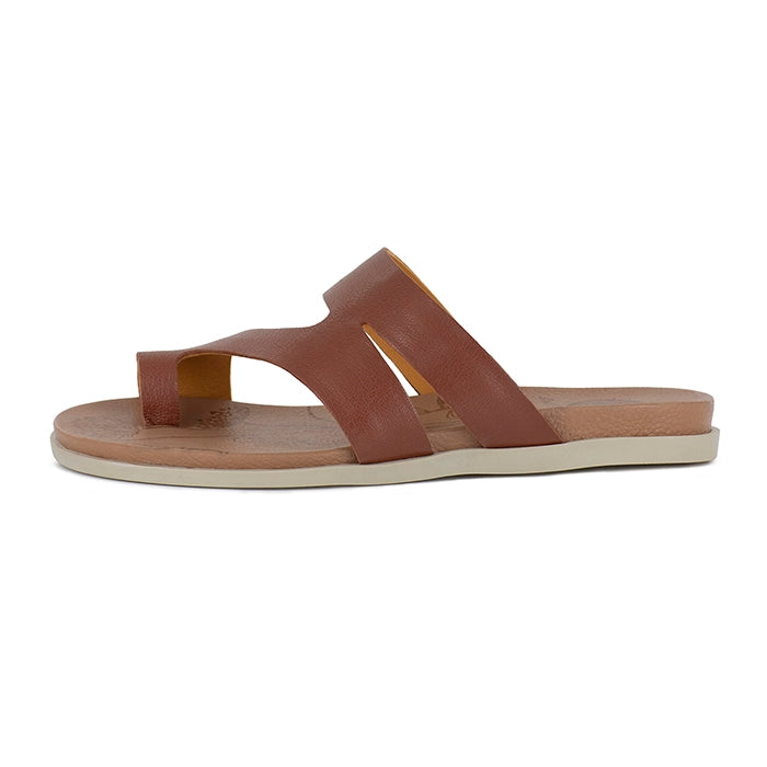 Brown sandal with a off-white sole on a white background