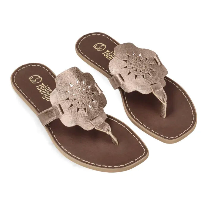 A pair of women's thong sandals with metallic rose gold floral cutout straps and brown footbeds, shown on a plain white background.