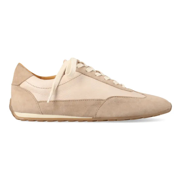 A low-top sneaker in beige and cream tones, featuring a mix of smooth leather and suede panels, cream laces, and a light tan sole, shown in a side profile on a white background.