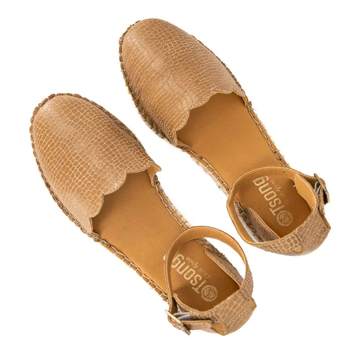 Pair of tan espadrille shoes on a white background