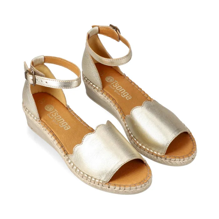 Gold wedge sandals with 'Tsong' branding on a white background