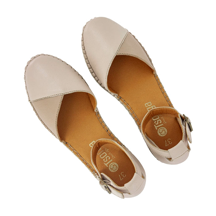 Pair of beige wedge shoes with a brand logo on a white background