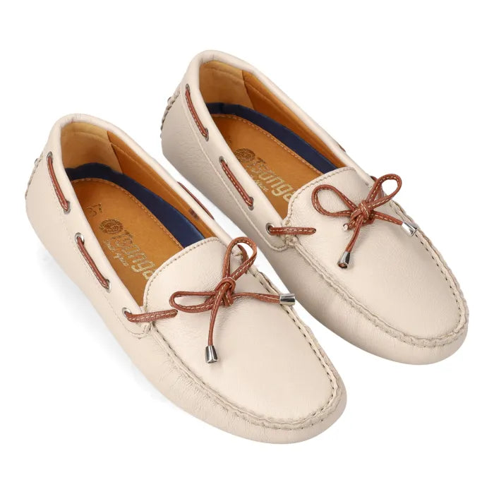 Pair of cream-colored loafers with brown laces on a white background