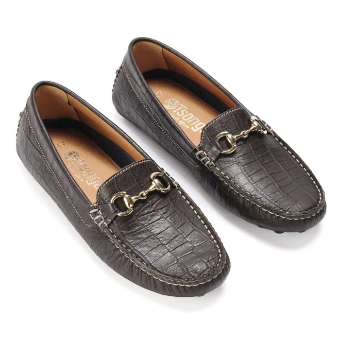 Pair of brown leather loafers with gold accents on a white background
