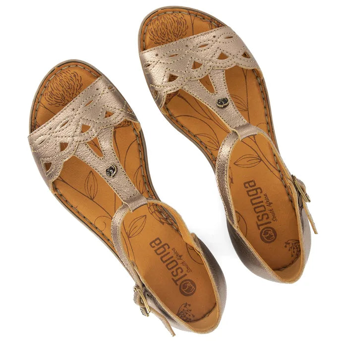 Pair of gold sandals with detailed straps on a white background