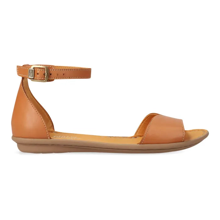 A tan leather flat sandal with an ankle strap and buckle, shown in a side profile view against a white background.