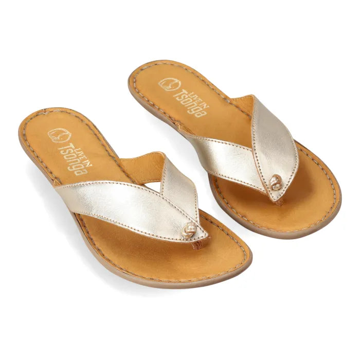 A pair of metallic gold leather thong sandals with tan footbeds, shown on a clean white background.