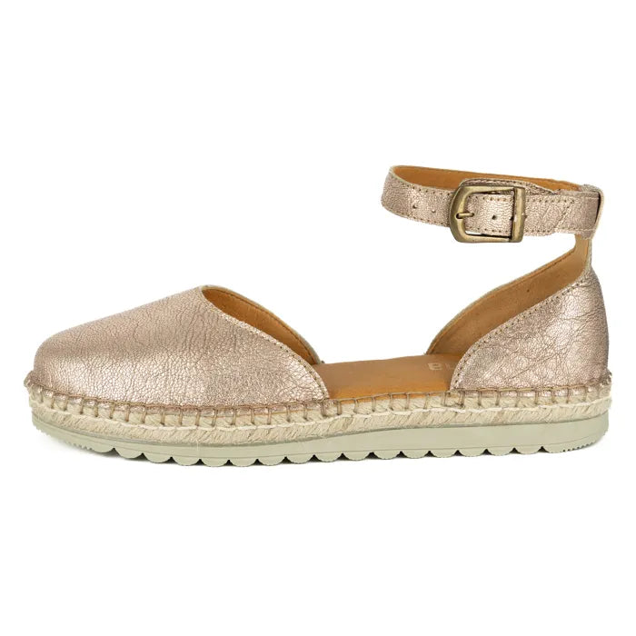 Gold espadrille sandal with a buckle on a white background