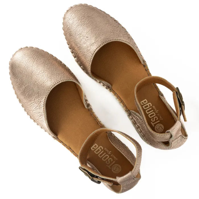 Pair of gold espadrille sandals on a white background