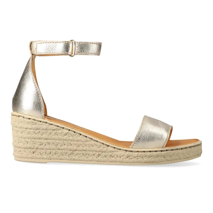 Gold wedge sandal with espadrille sole on a white background