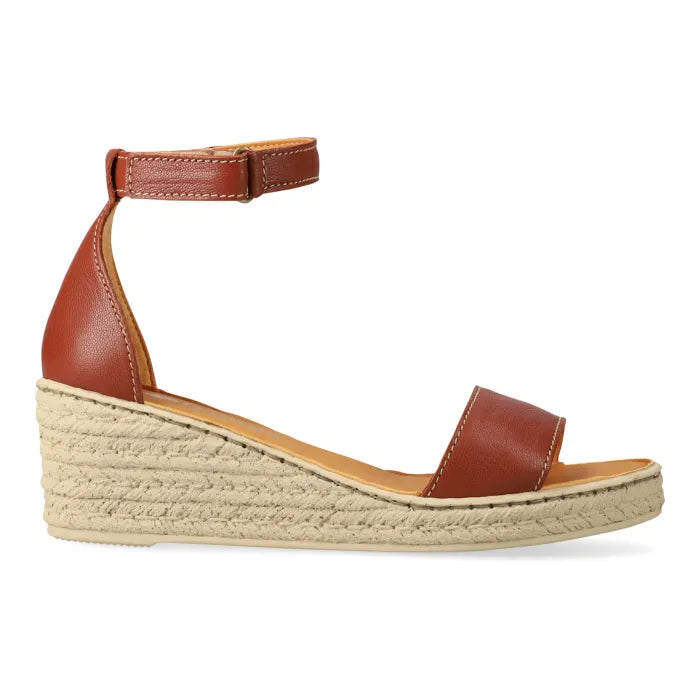 Brown wedge sandal with espadrille print sole on a white background