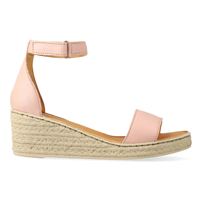 Pink wedge sandal with espadrille print sole on a white background