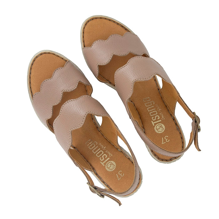 Pair of beige sandals with a scalloped edge design on a white background