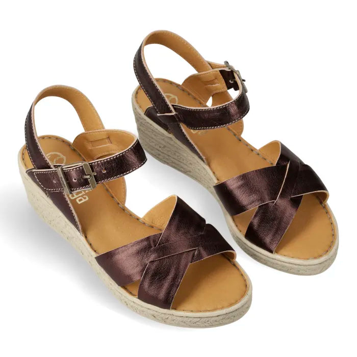 A pair of women's wedge sandals with metallic dark brown leather straps and a tan insole, shown on a white background.
