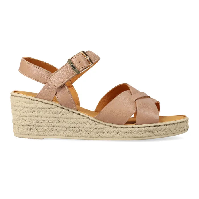 A single women's espadrille wedge sandal in a light tan leather finish, featuring criss-cross front straps, an adjustable ankle strap with a silver-tone buckle, and a braided jute wedge heel, shown against a plain white background.