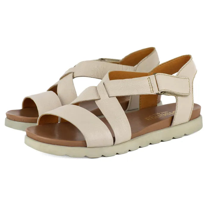 Beige sandals with criss-cross straps on a white background