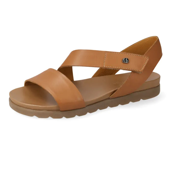 A tan leather slide sandal with a low wedge sole, shown from a side profile on a white background.