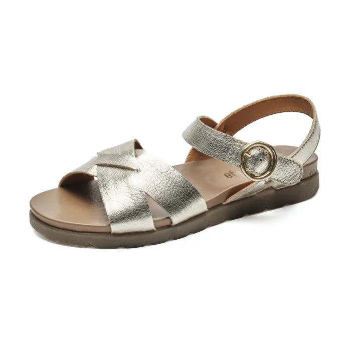 A single metallic silver leather sandal with crisscrossing straps, an adjustable ankle strap with a round metal buckle, and a brown sole, shown on a plain white background.