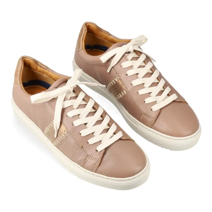Pair of beige sneakers with white laces on a white background