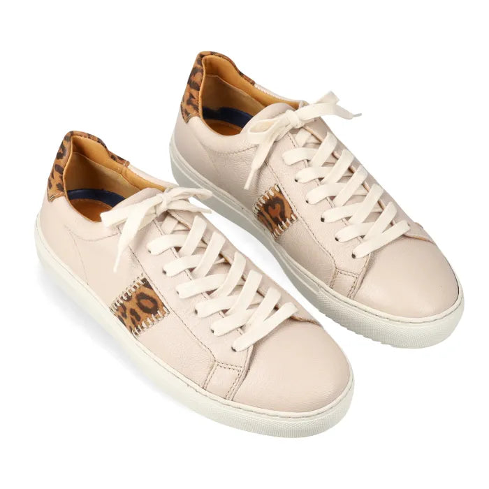 Pair of cream sneakers with leopard print accents on a white background