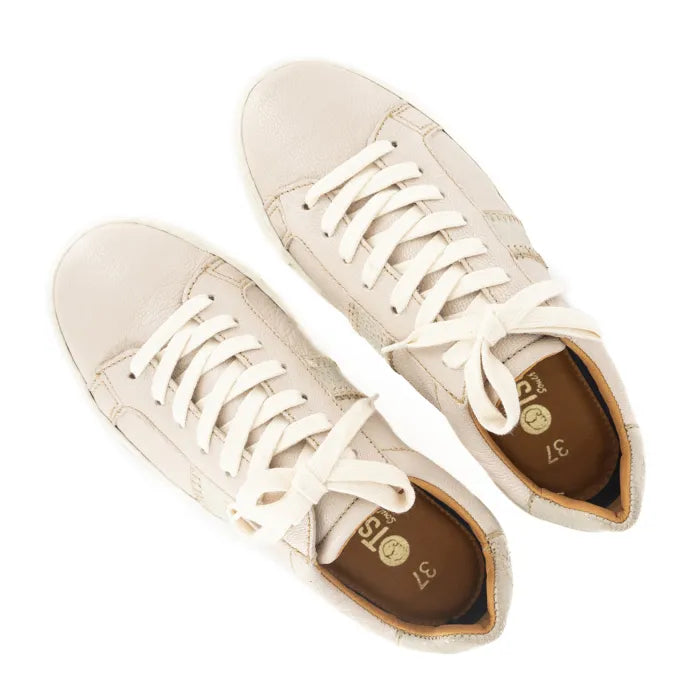 Pair of cream-colored sneakers with white laces on a white background