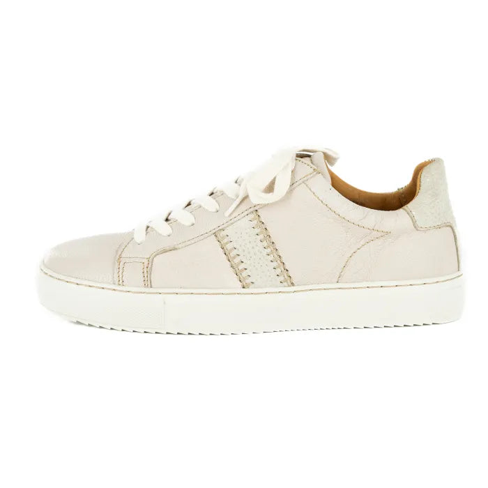 Cream sneaker with white laces on a white background