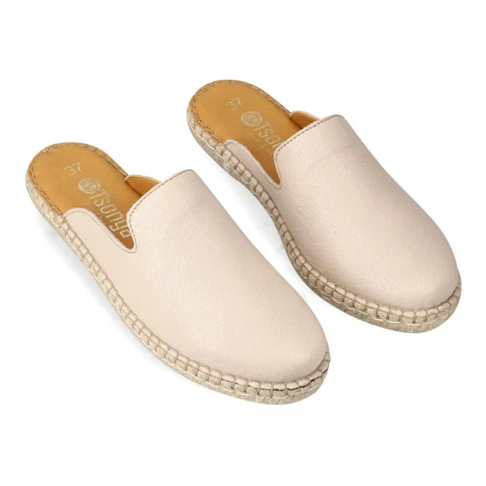 Pair of beige espadrille mules on a white background