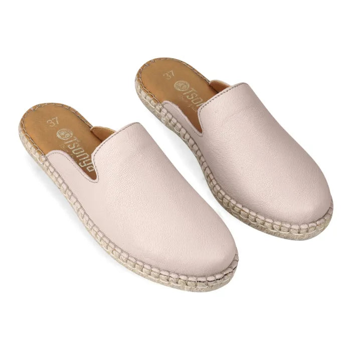 Pair of beige espadrille slip-ons on a white background