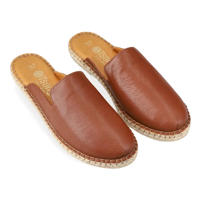 Pair of brown leather espadrilles on a white background