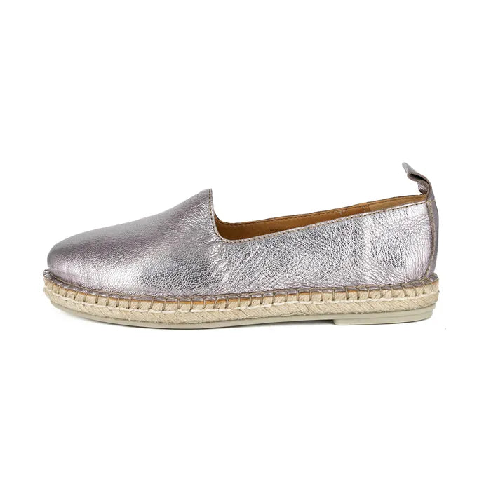 Pink metallic espadrille shoe on a white background