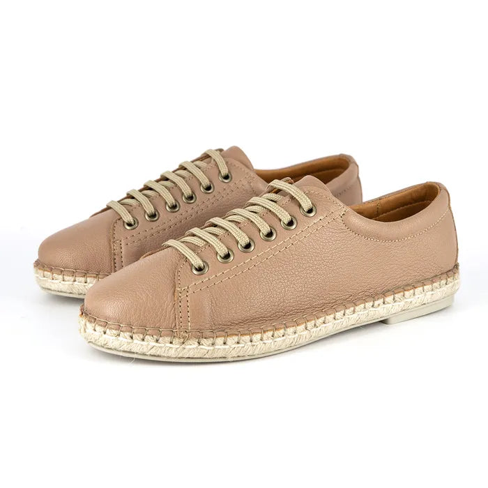 Pair of beige sneakers with light brown laces on a white background