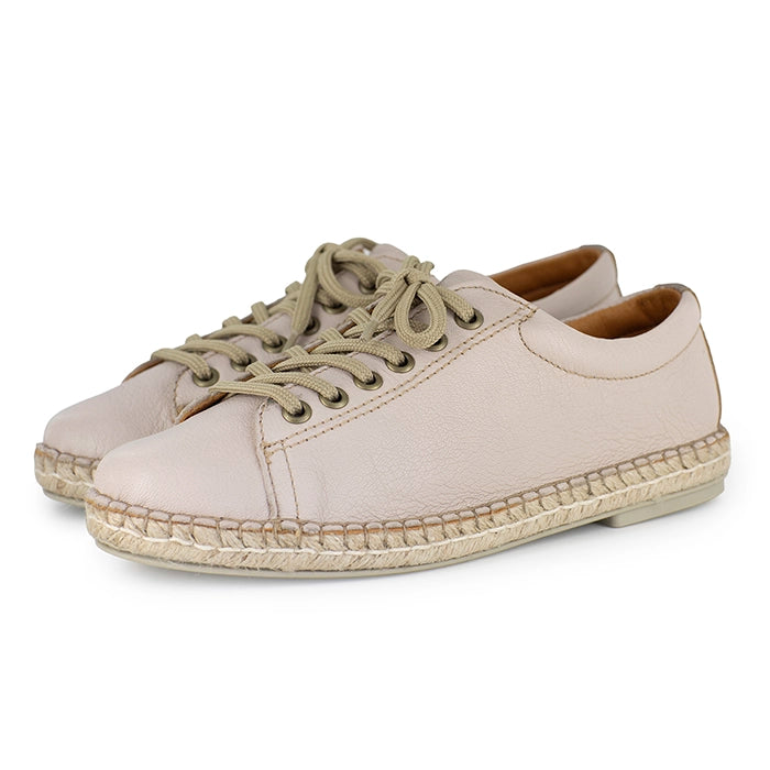 Pair of beige sneakers with espadrille soles on a white background