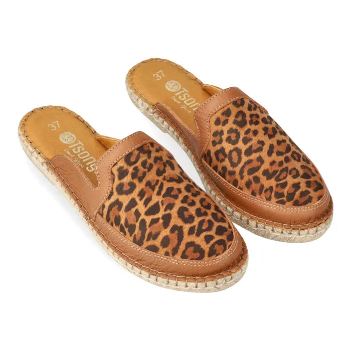 Pair of spotted print mules with brown soles on a white background