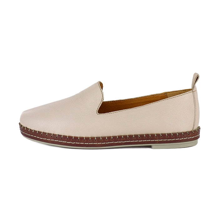 Beige slip-on shoe with brown sole on a white background