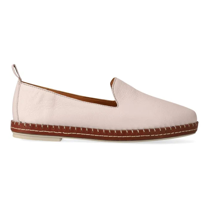 Beige flat shoe with brown sole on a white background