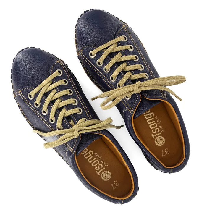 Pair of navy blue sneakers with beige laces on a white background