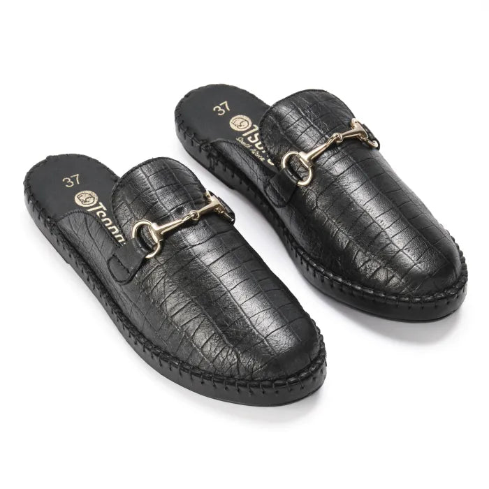 Black patterned slipons with gold accents on a white background