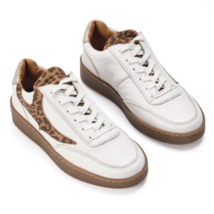 White sneakers with leopard print accents on a white background