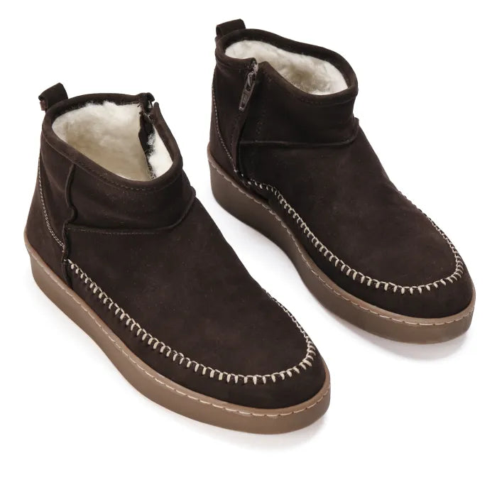 Pair of brown suede boots with white interior on a white background