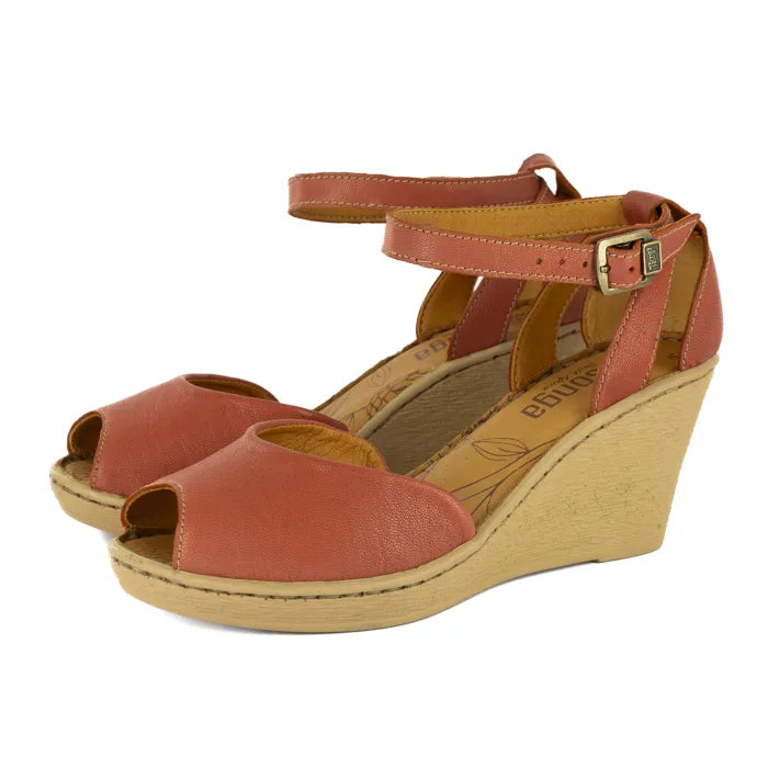 Pair of brown wedge sandals with ankle straps on a white background