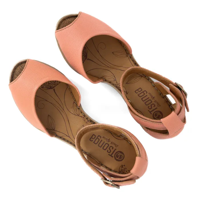 Pair of coral sandals on a white background