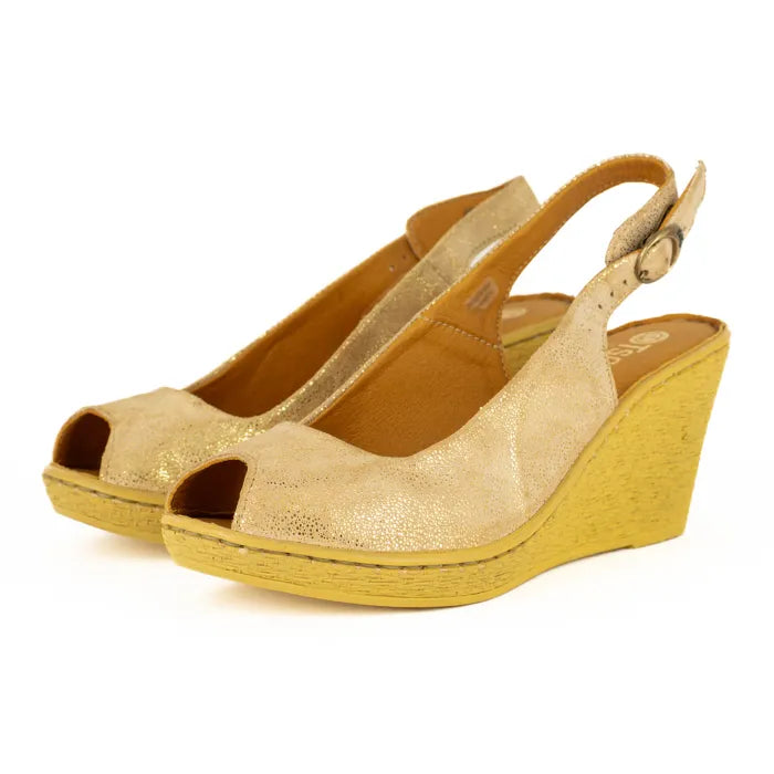 Gold wedge sandals on a white background