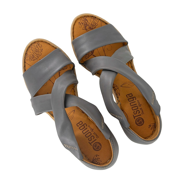 Pair of grey sandals with tan soles on a white background