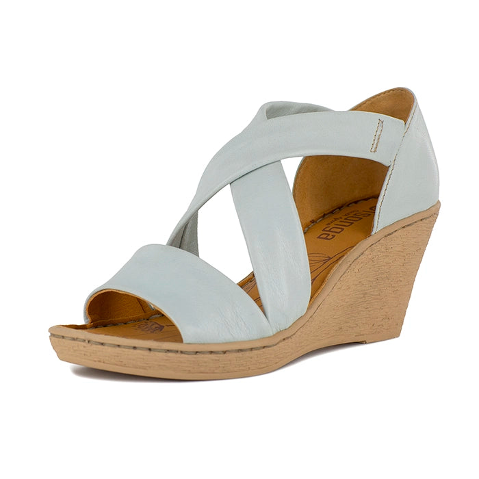 Pale blue wedge sandal with beige sole on a white background