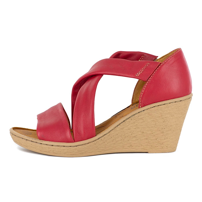 Red wedge sandal with a beige sole on a white background